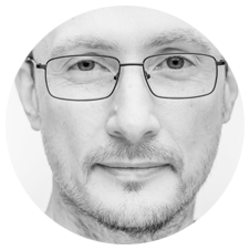 Black and white headshot photo of Eugen Borcan - male, caucasian, short hair, adult in his 40s, wearing glasses with thin rectangular frames.